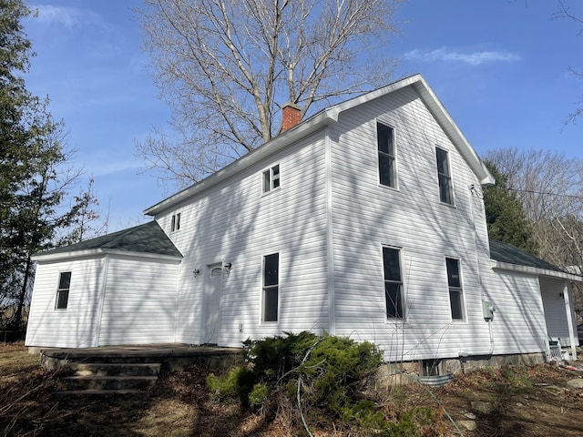 view of side of home featuring a chimney