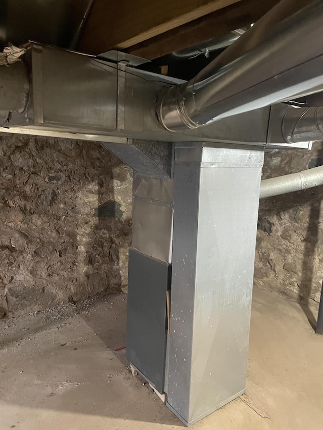unfinished below grade area featuring heating unit