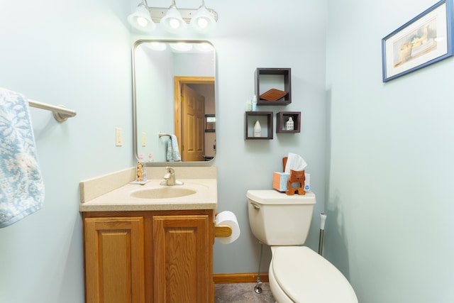 half bathroom featuring toilet and vanity