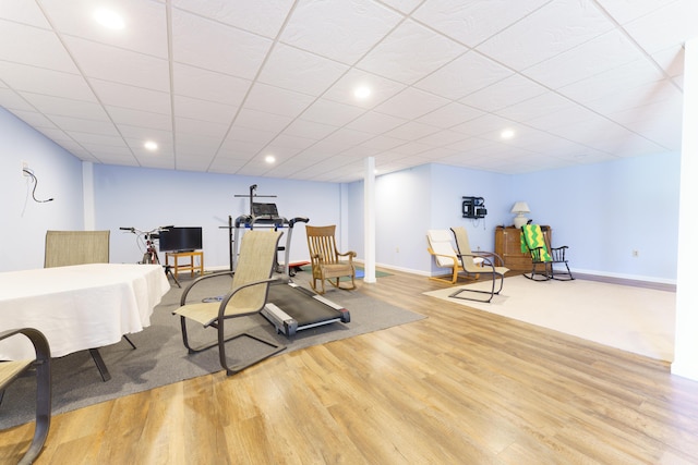 exercise room with recessed lighting, wood finished floors, and baseboards