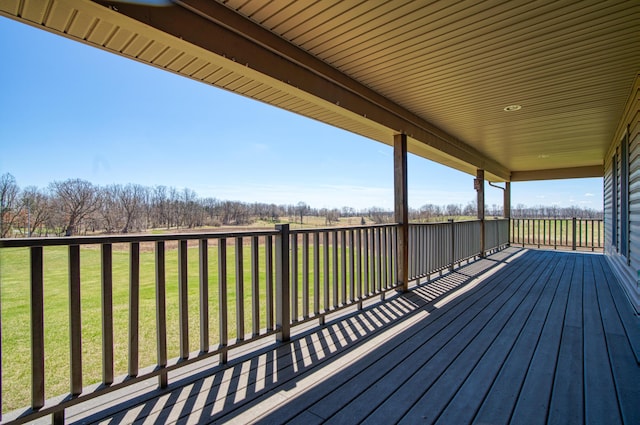 wooden terrace featuring a yard