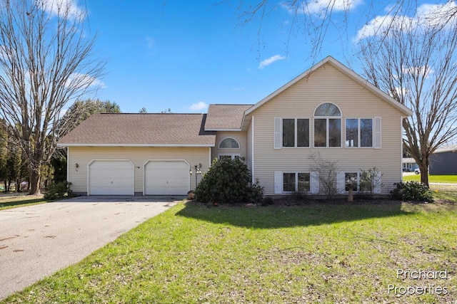 tri-level home with an attached garage, a front lawn, roof with shingles, and concrete driveway