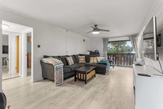 living area featuring light wood finished floors, a ceiling fan, and crown molding