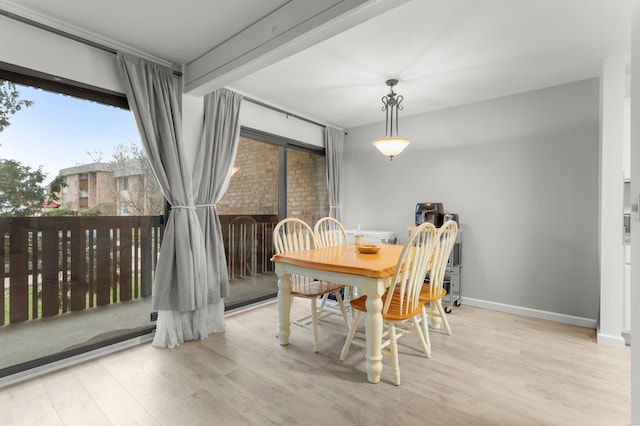 dining space with wood finished floors and baseboards