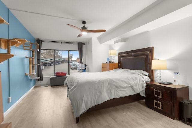 bedroom with light wood-style flooring, baseboards, and a ceiling fan