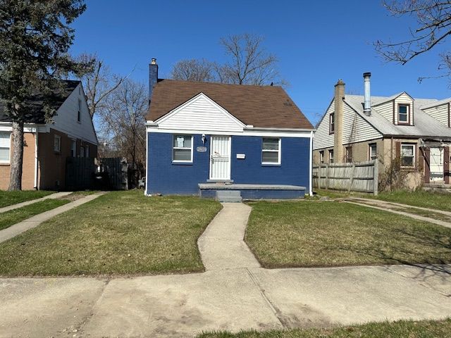 bungalow-style home featuring fence, a chimney, and a front yard
