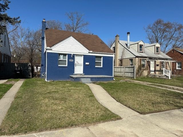 view of front facade featuring fence, a front lawn, and a chimney