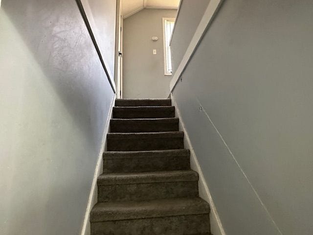 stairs featuring lofted ceiling