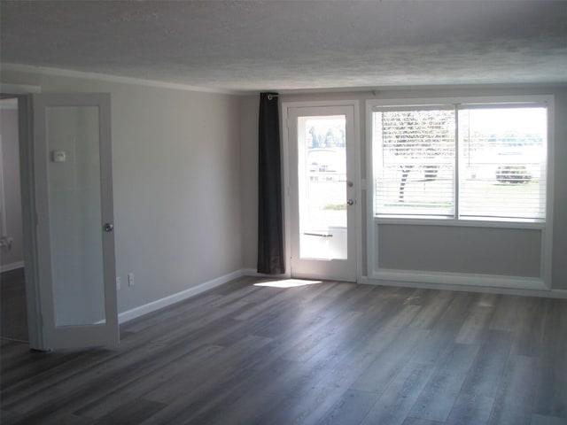 9920 Sashabaw Rd, Clarkston, MI 48348 - spare room featuring wood finished floors, a textured ceiling, and baseboards