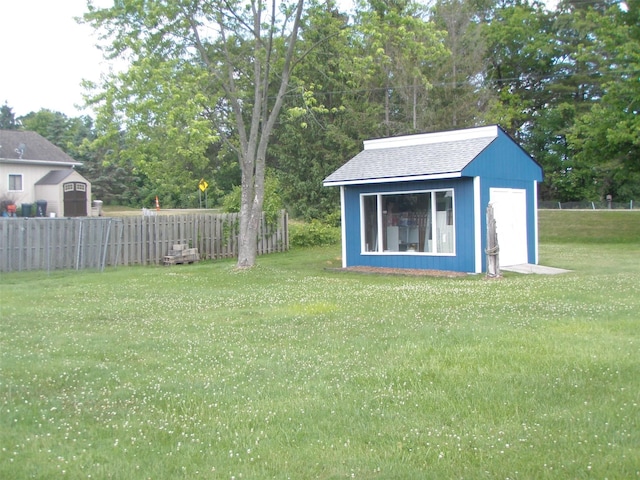 9920 Sashabaw Rd, Clarkston, MI 48348 - view of yard with a storage unit, an outbuilding, and fence