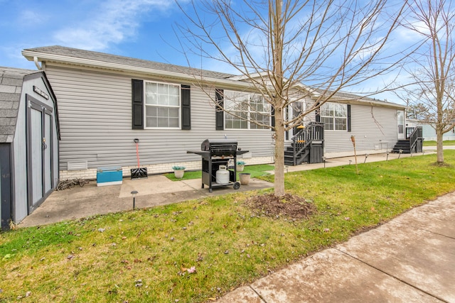 rear view of property featuring a patio area and a lawn
