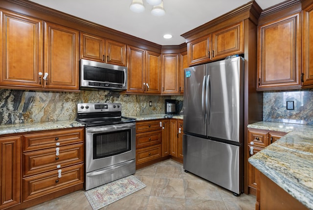 kitchen featuring brown cabinets, backsplash, and stainless steel appliances
