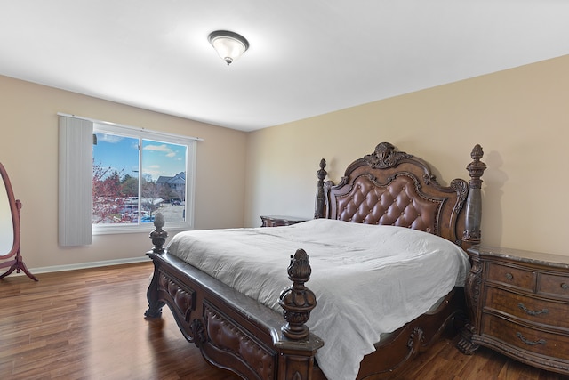 bedroom featuring baseboards and wood finished floors