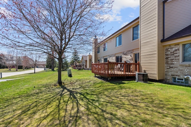 view of yard featuring a deck and cooling unit