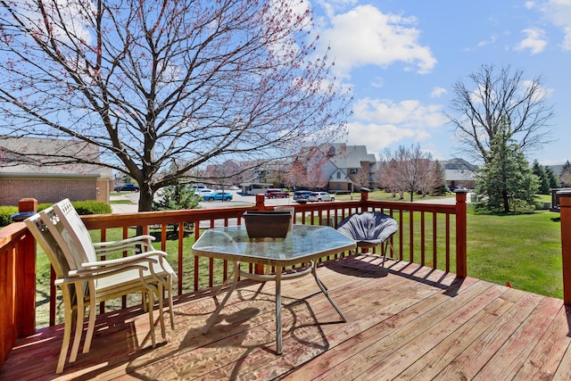 deck with a yard and a residential view