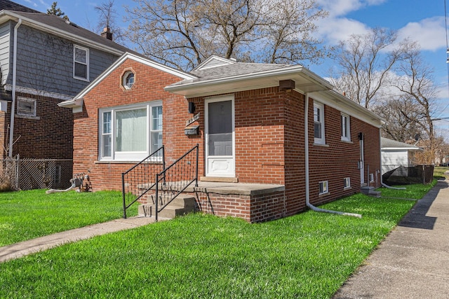 8911 Plainview Ave, Detroit, MI 48228 - bungalow-style house featuring fence, a front lawn, and brick siding