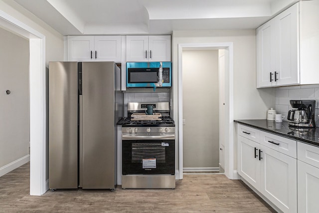 8911 Plainview Ave, Detroit, MI 48228 - kitchen with decorative backsplash, stainless steel appliances, and white cabinets