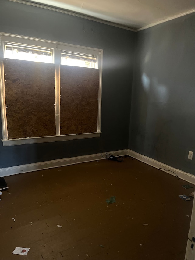 empty room with baseboards and ornamental molding