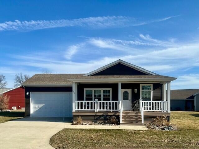 5652 Kingsley Dr NE, Rockford, MI 49341 - ranch-style house featuring an attached garage, a porch, and concrete driveway