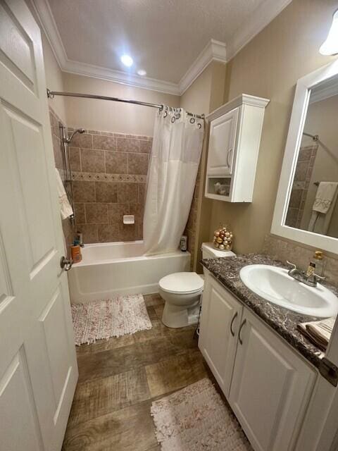 5652 Kingsley Dr NE, Rockford, MI 49341 - full bathroom featuring wood finished floors, vanity, toilet, ornamental molding, and shower / bath combo with shower curtain