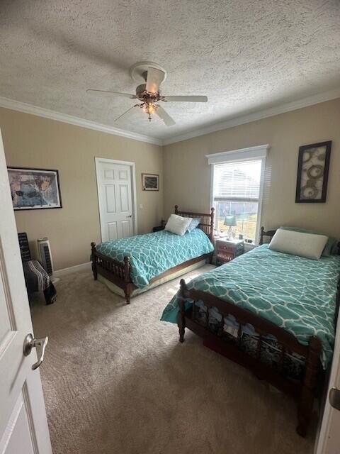 5652 Kingsley Dr NE, Rockford, MI 49341 - carpeted bedroom featuring a ceiling fan, baseboards, crown molding, and a textured ceiling