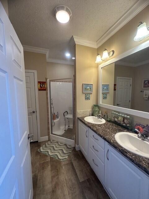 5652 Kingsley Dr NE, Rockford, MI 49341 - full bath with a textured ceiling, wood finished floors, a sink, and a shower stall