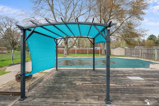 view of property's community with a fenced backyard, an outdoor structure, a deck, and a storage shed