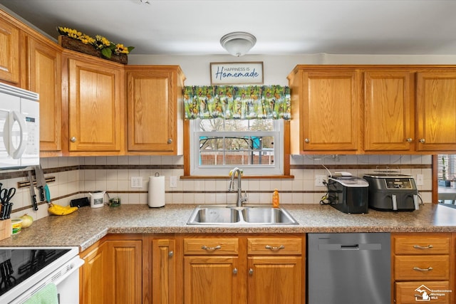 kitchen with decorative backsplash, white appliances, a sink, and brown cabinetry