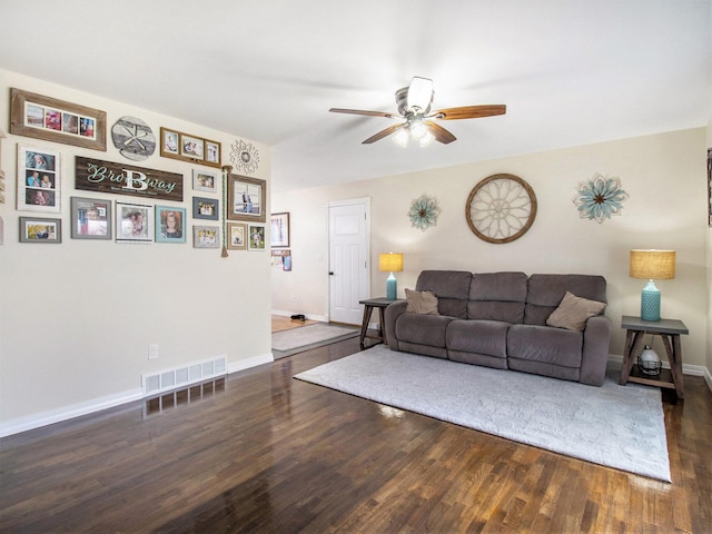 living area featuring wood finished floors, baseboards, a ceiling fan, and visible vents