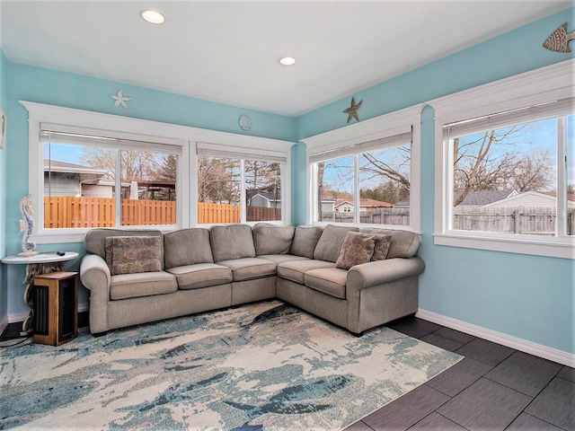 living area featuring a wealth of natural light and baseboards