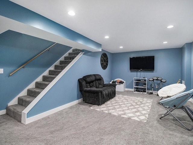 carpeted living room with baseboards, stairs, and recessed lighting