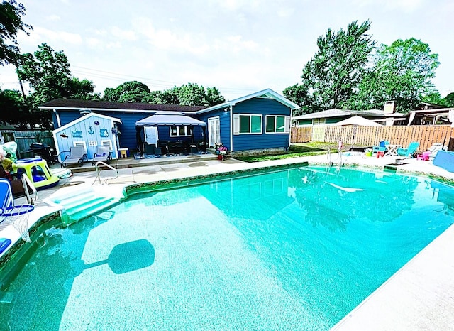 view of swimming pool with a fenced backyard, a patio, and a fenced in pool