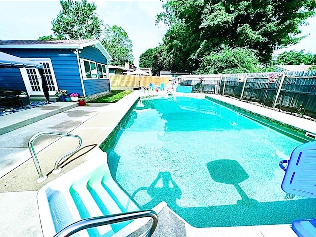 view of swimming pool with a fenced in pool, a patio, and a fenced backyard