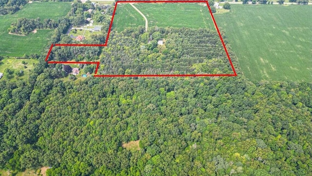 birds eye view of property featuring a rural view and a wooded view