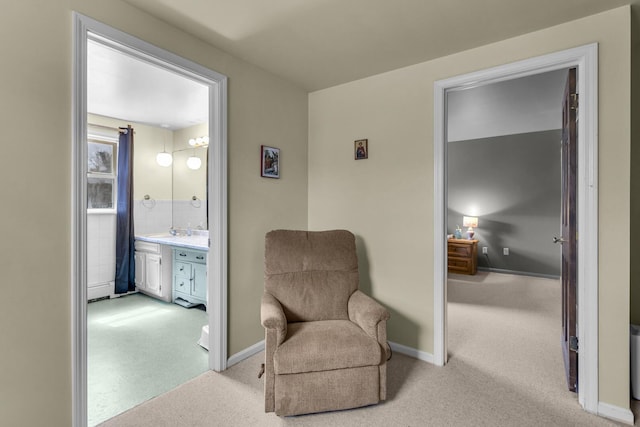 sitting room with light colored carpet and baseboards