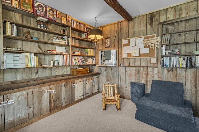 living area with beam ceiling, wooden walls, and carpet floors