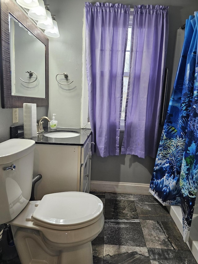 1070 W Broadway Ave, Muskegon, MI 49441 - full bathroom with baseboards, toilet, vanity, and a shower with curtain