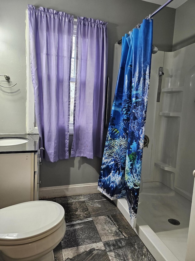 1070 W Broadway Ave, Muskegon, MI 49441 - bathroom with a shower stall, vanity, toilet, and baseboards