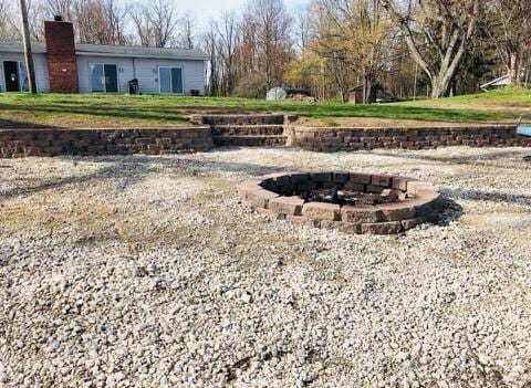 view of yard with a fire pit