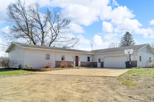 single story home with a garage, brick siding, and concrete driveway