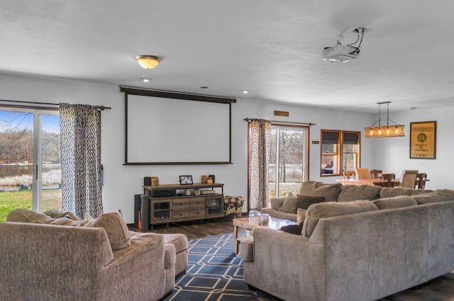 cinema featuring a chandelier, dark wood-style floors, and recessed lighting