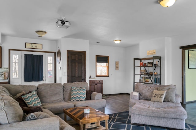 living room with baseboards and dark wood-style floors