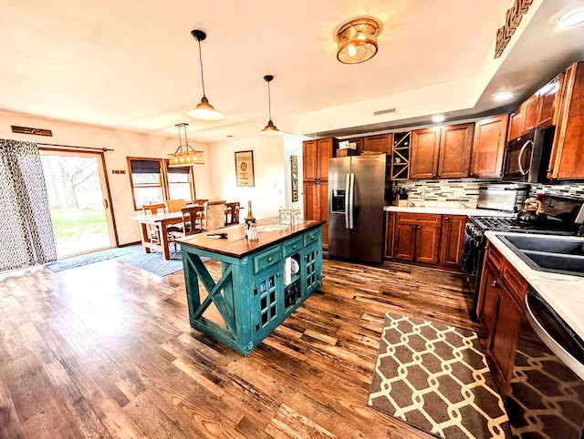 kitchen featuring dark wood-style floors, backsplash, stainless steel fridge with ice dispenser, open shelves, and dishwasher