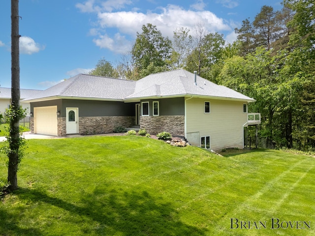 6817 Martin View St NE, Rockford, MI 49341 - rear view of property with an attached garage, a yard, stone siding, and concrete driveway
