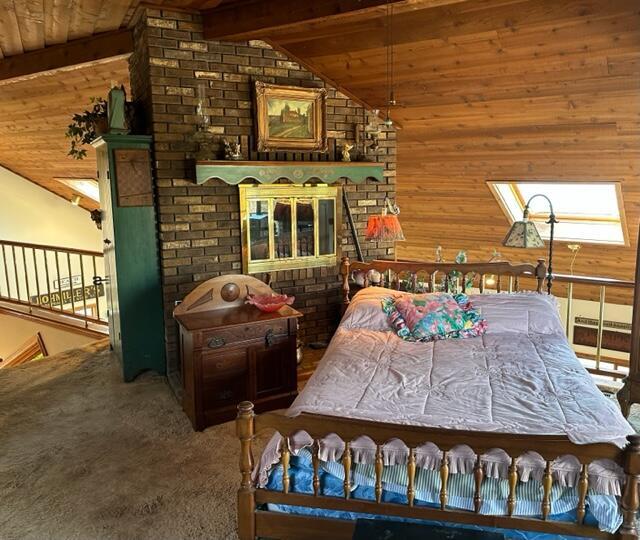 bedroom with wood walls, vaulted ceiling with beams, wooden ceiling, and carpet flooring