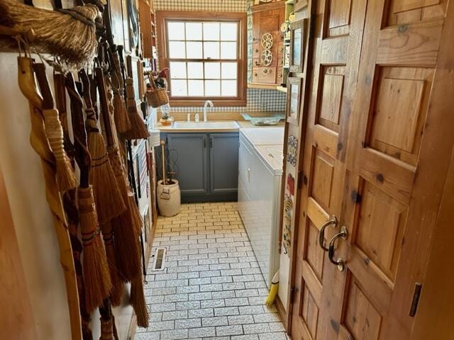 bathroom with vanity, washer and dryer, and visible vents