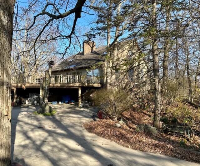 view of front of property with a chimney and a deck