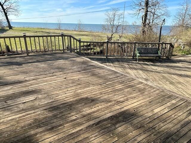 wooden terrace featuring a water view