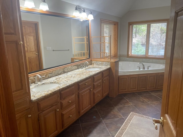 full bathroom featuring lofted ceiling, tile patterned floors, and a sink