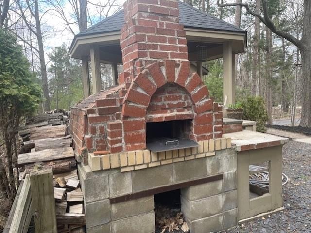 exterior space featuring an outdoor brick fireplace